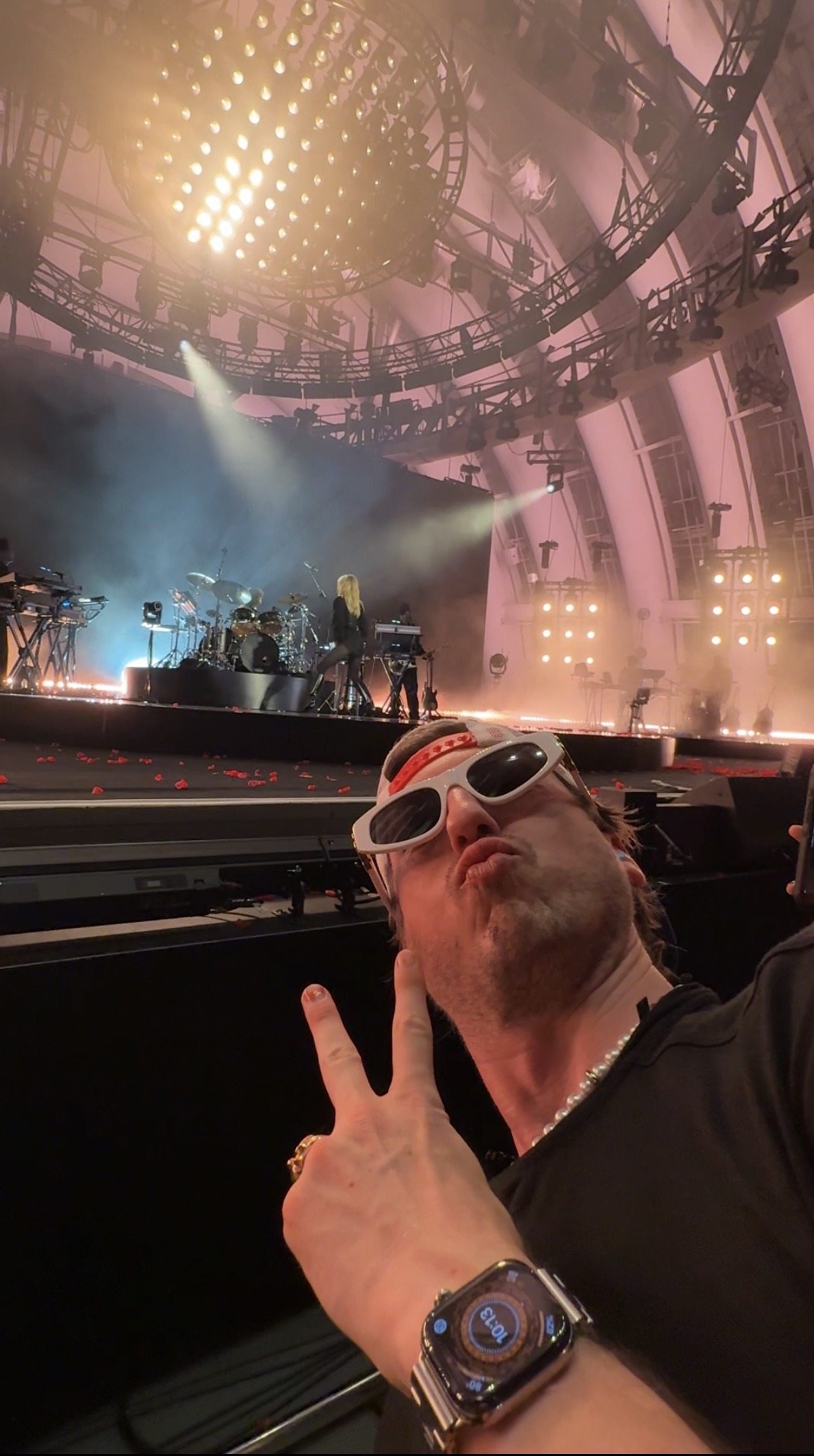 Joe front row at the Hollywood Bowl, Miley Cyrus on stage behind him